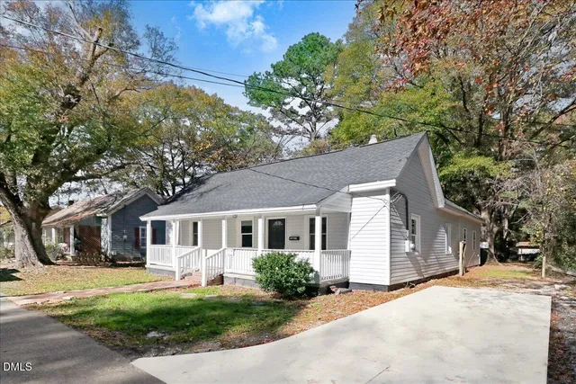 a view of a house with a yard patio and fire pit