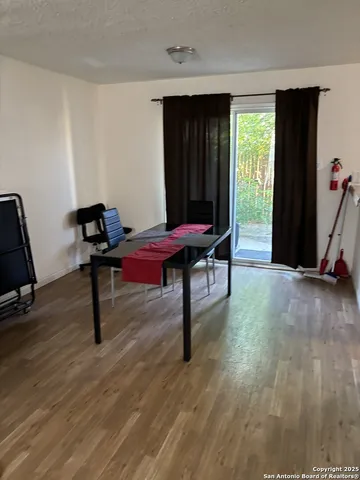 a view of a workspace with furniture and a window