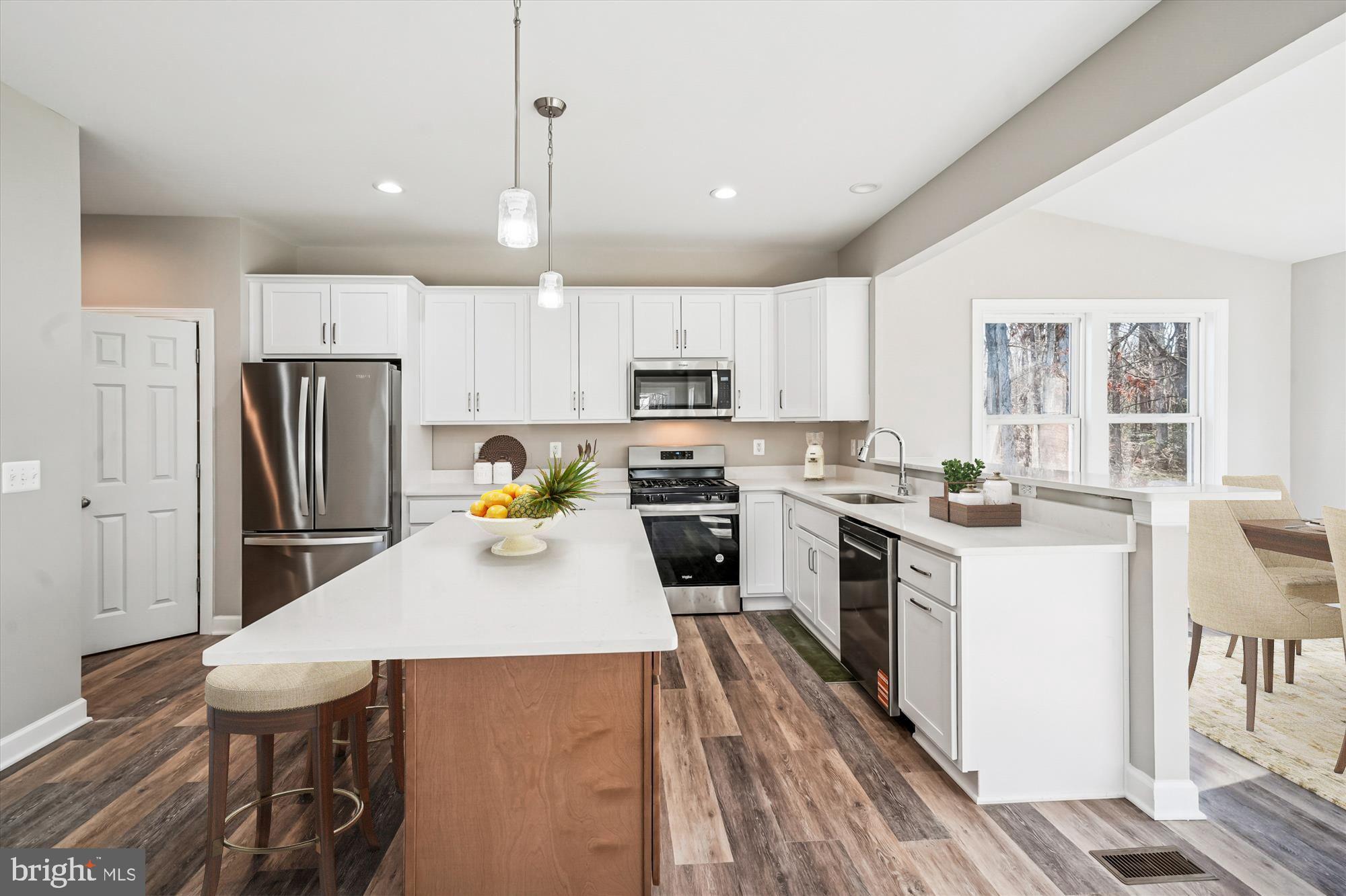 292 Colebrook Road Fredericksburg, VA 22405 - Photo 15 of 67 a kitchen with a table chairs refrigerator and microwave