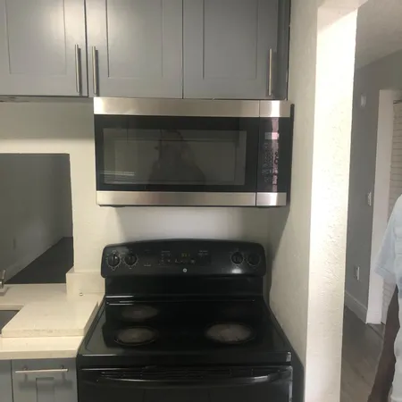 a kitchen with a stove and a microwave