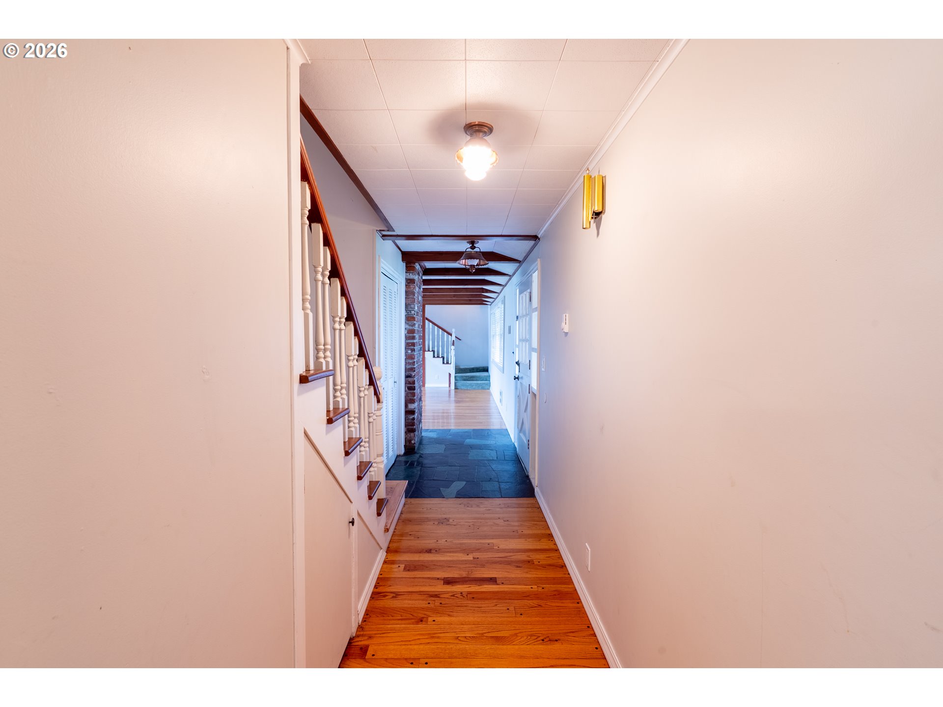 825 Filbert Avenue Eugene, OR 97404 - Photo 12 of 35 a view of a hallway with wooden floor and staircase