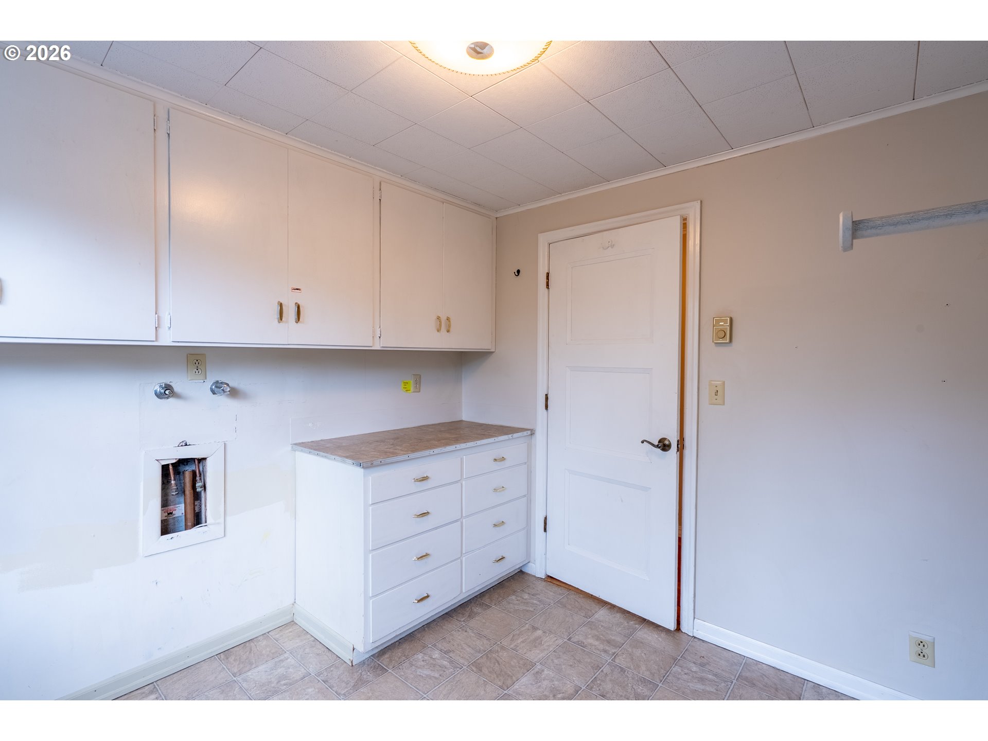 825 Filbert Avenue Eugene, OR 97404 - Photo 18 of 35 a kitchen with white cabinets and a stove top oven
