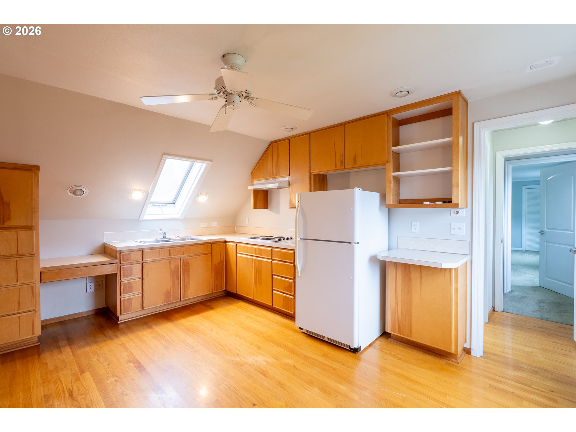 825 Filbert Avenue Eugene, OR 97404 - Photo 27 of 35 a kitchen with a refrigerator a sink and dishwasher with wooden floor