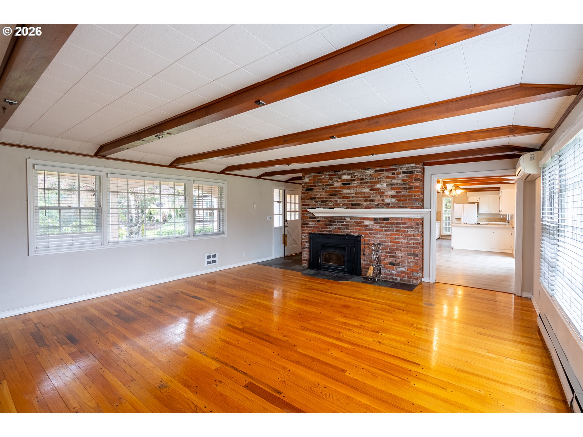 825 Filbert Avenue Eugene, OR 97404 - Photo 7 of 35 a view of an empty room with a fireplace and a window