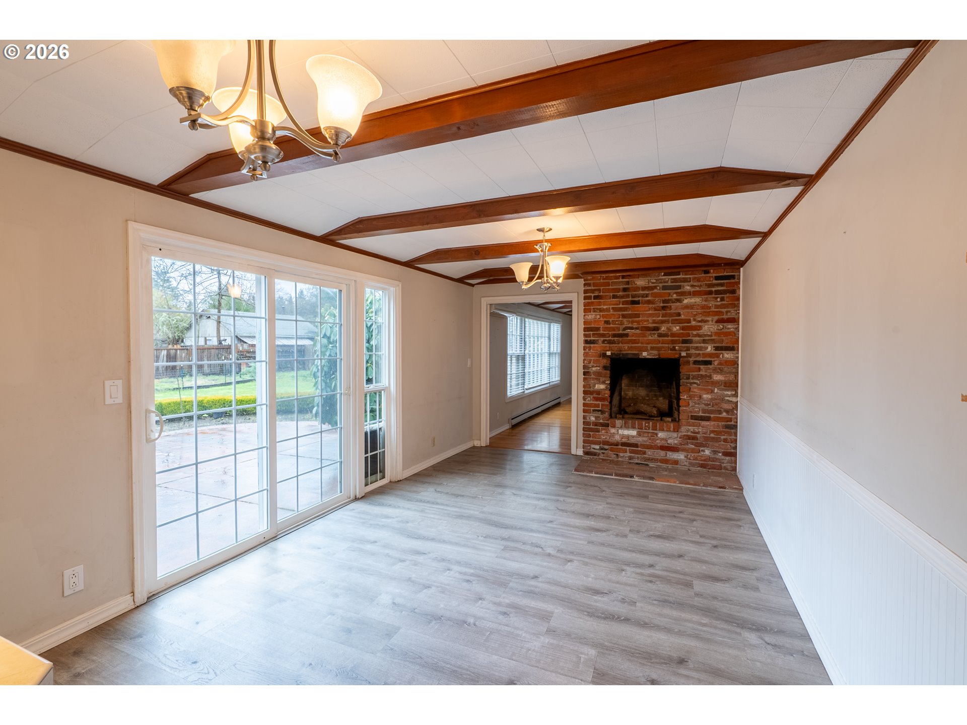 825 Filbert Avenue Eugene, OR 97404 - Photo 8 of 35 a view of empty room with wooden floor and fireplace