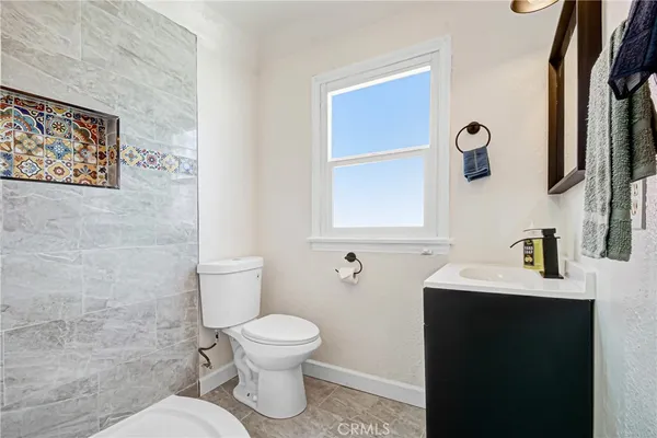 a bathroom with a toilet sink and mirror