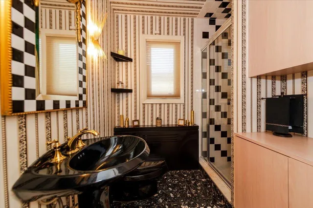 a bathroom with a sink a mirror and a shower curtain