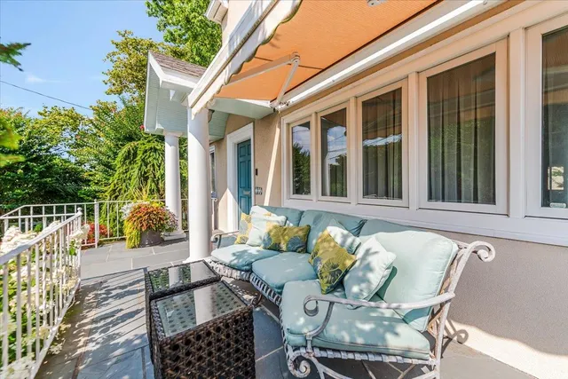 a view of a patio with a table and chairs and potted plants