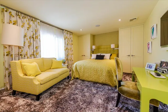 a bedroom with a bed and a couch