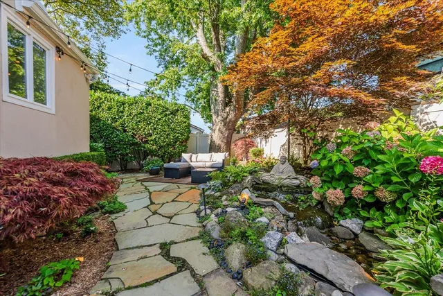 a view of a backyard with sitting area