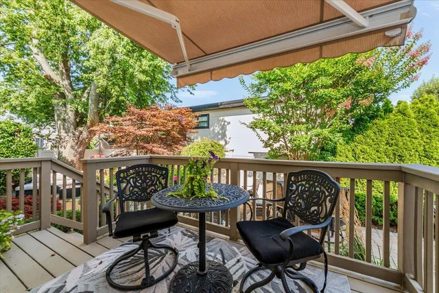 a view of a chairs and table in the balcony