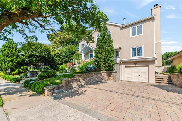 a front view of a house with a yard and a garage