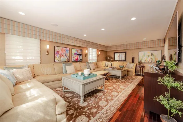 a living room with lots of furniture and a potted plant