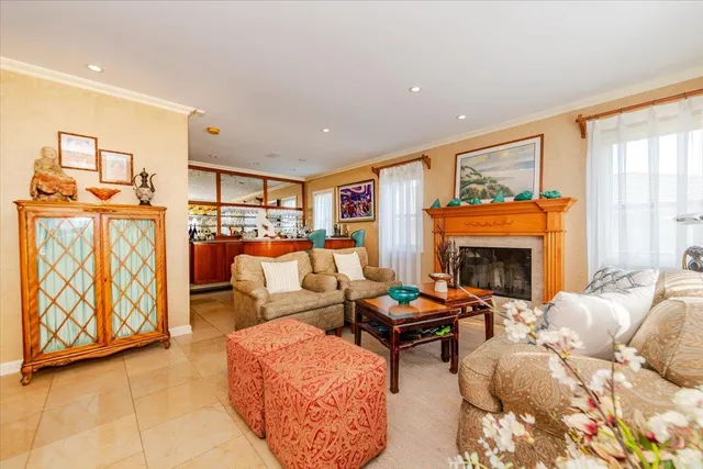 a living room with furniture a fireplace and a large window