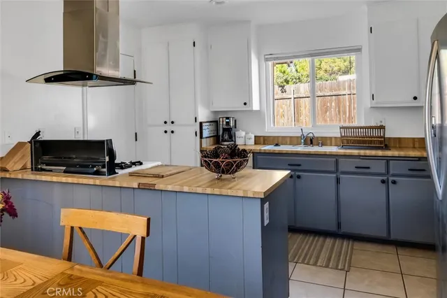 a kitchen with stainless steel appliances granite countertop a sink a stove a counter space and cabinets