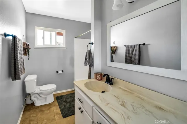 a bathroom with a sink toilet and mirror