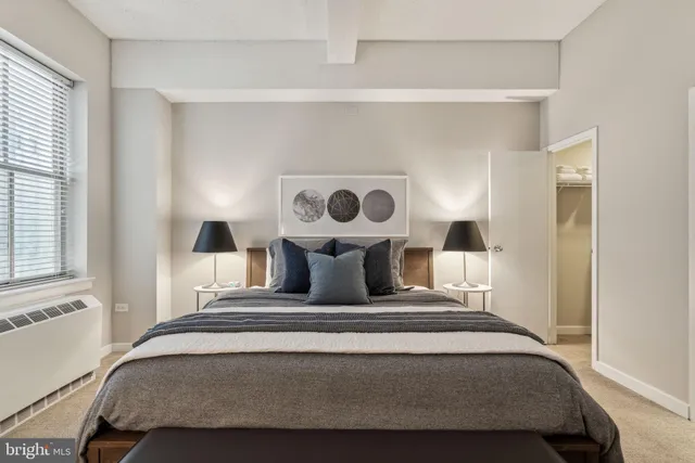 a bedroom with a bed and window