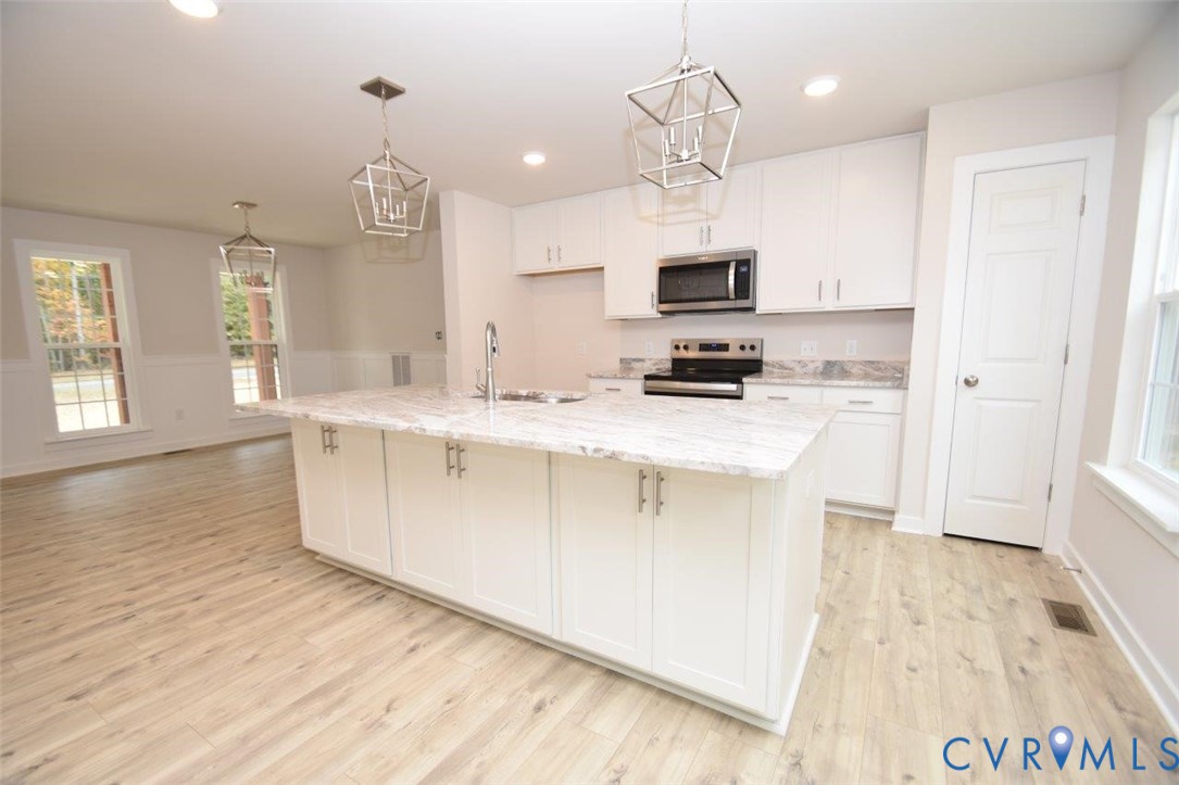 375 Amick Road Louisa, VA 23093 - Photo 5 of 25 a kitchen with stainless steel appliances a sink stove and refrigerator