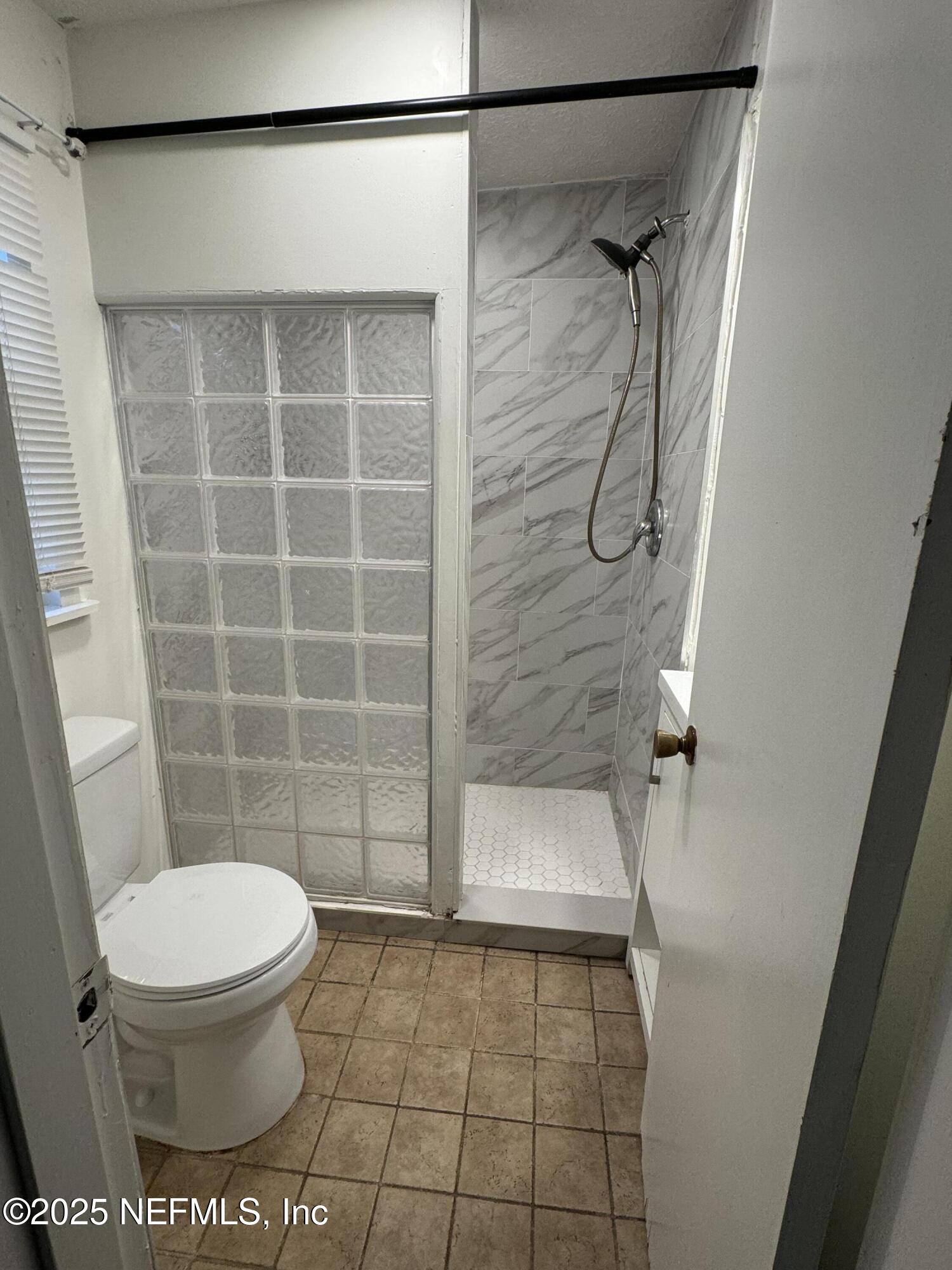 9359 Orme Road Jacksonville, FL 32220 - Photo 9 of 9 a bathroom with a toilet and a shower