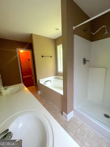 a bathroom with a tub and shower