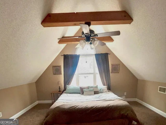 a bedroom with a bed and a ceiling fan