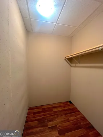 a view of a room with wooden floor and staircase