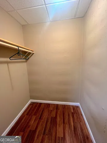 a view of a room with wooden floor