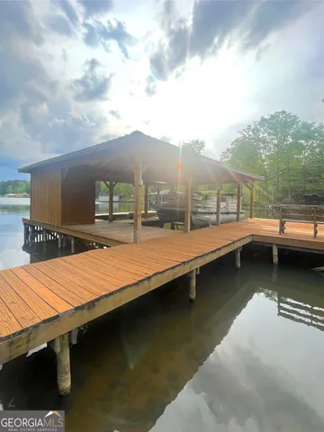 a view of swimming pool with outdoor seating and barbeque oven