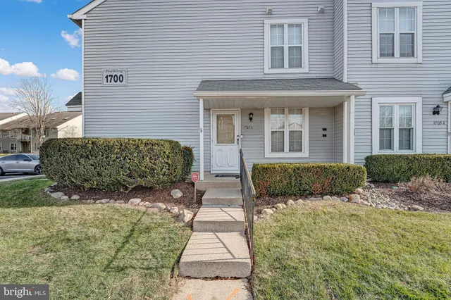 a view of a house with potted plants