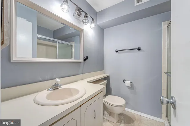 a bathroom with a sink toilet and mirror