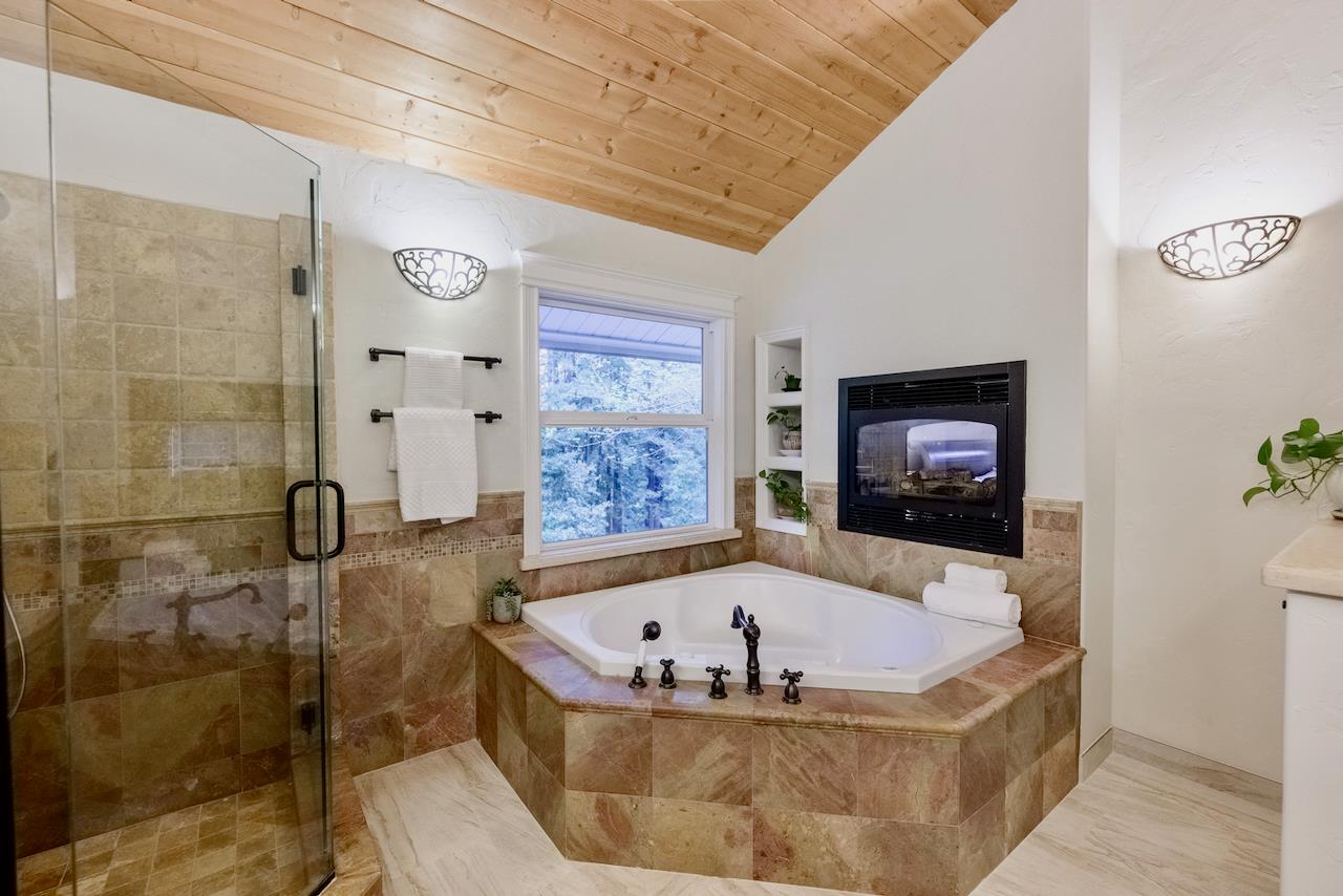 295 Jim's Road Ben Lomond, CA 95005 - Photo 20 of 139 a bath tub sitting in a bathroom next to a window