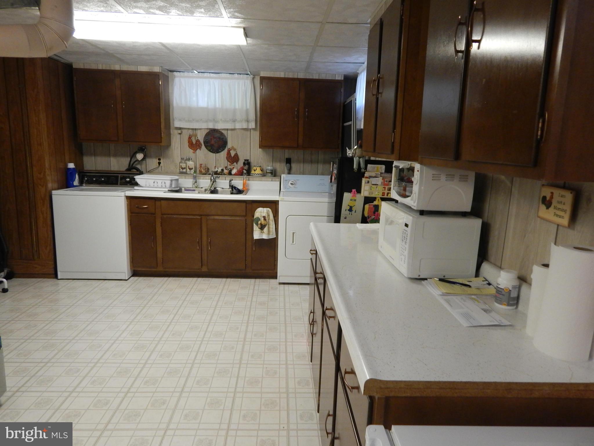 9114 Kilbride Road Baltimore, MD 21236 - Photo 22 of 27 a kitchen with a sink appliances and cabinets