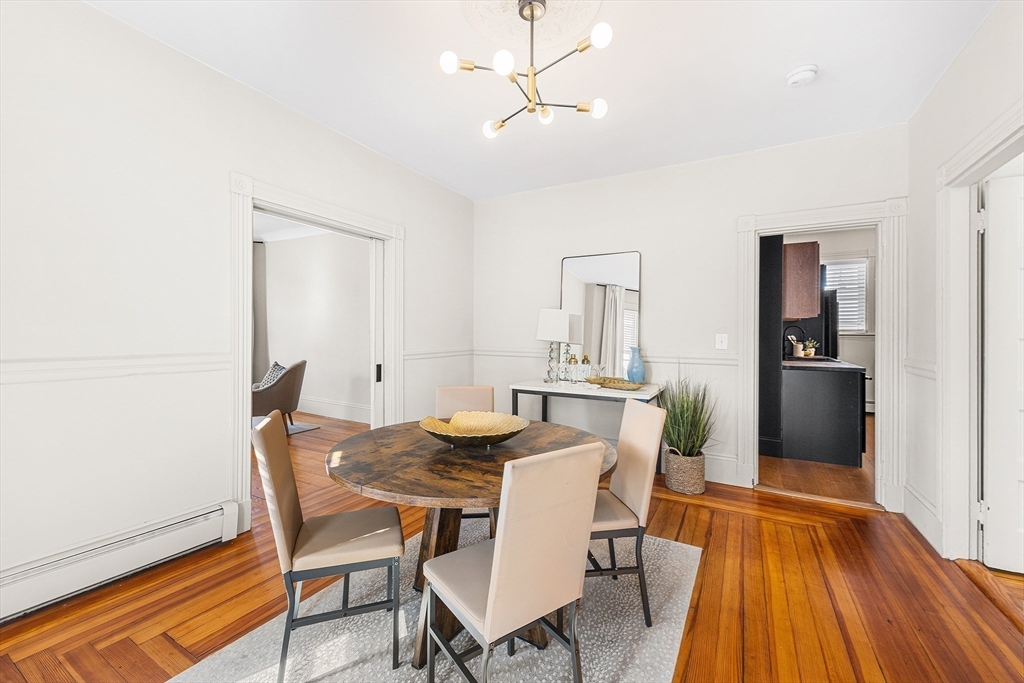 8 Spring Garden Street, Unit 3 Boston, MA 02125 - Photo 11 of 37 a view of a dining room with furniture and wooden floor
