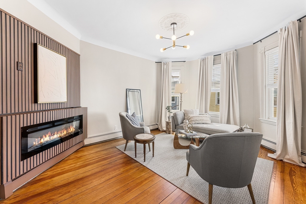 8 Spring Garden Street, Unit 3 Boston, MA 02125 - Photo 2 of 37 a living room with furniture and a fireplace