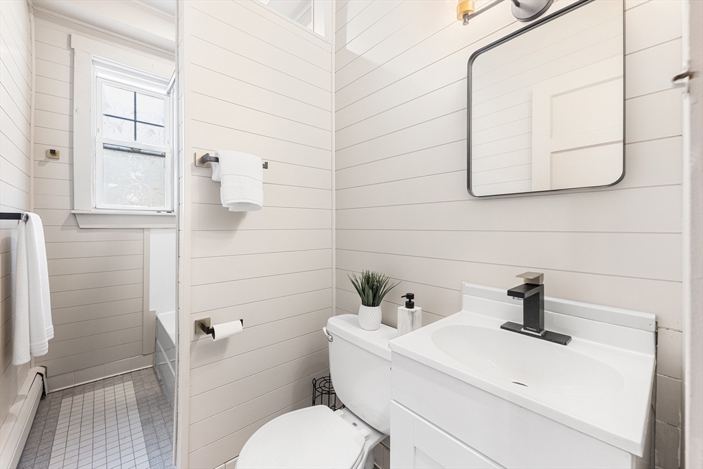 8 Spring Garden Street, Unit 3 Boston, MA 02125 - Photo 21 of 37 a bathroom with a sink a toilet and mirror