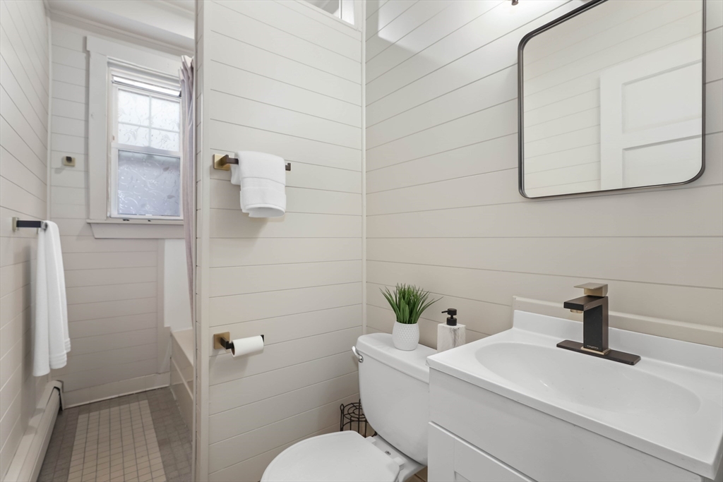8 Spring Garden Street, Unit 3 Boston, MA 02125 - Photo 22 of 37 a bathroom with a sink a toilet and mirror