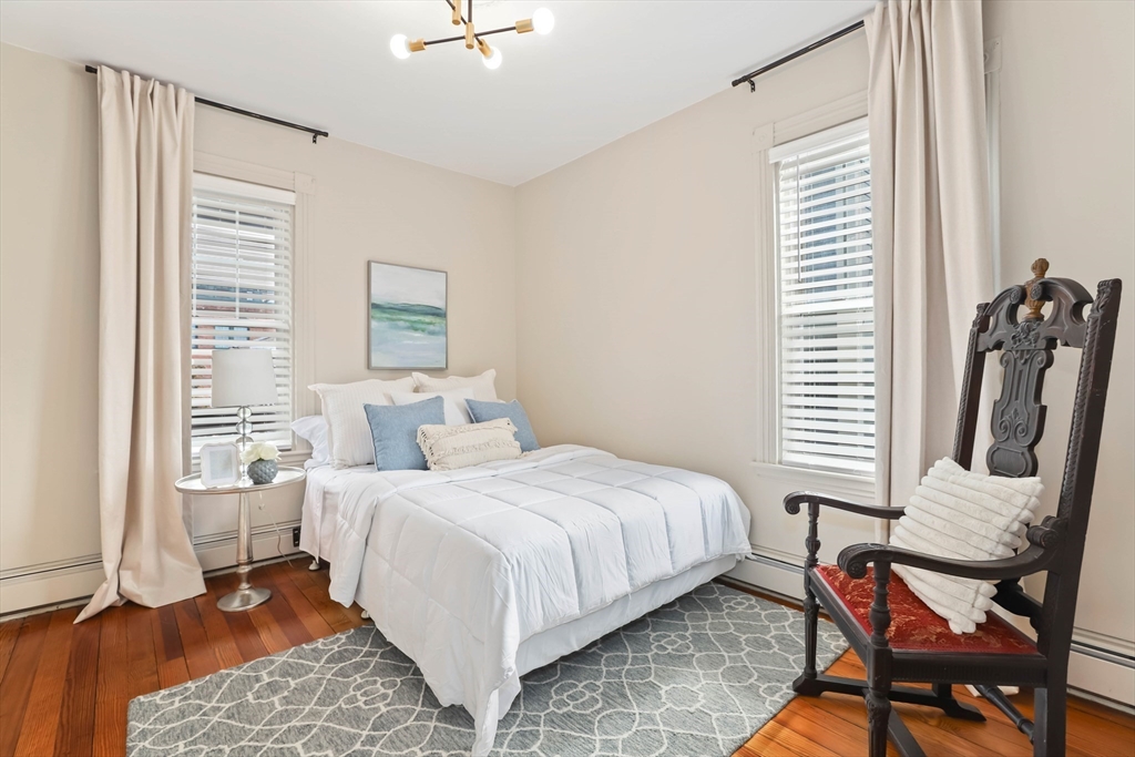 8 Spring Garden Street, Unit 3 Boston, MA 02125 - Photo 23 of 37 a bedroom with a bed and a window