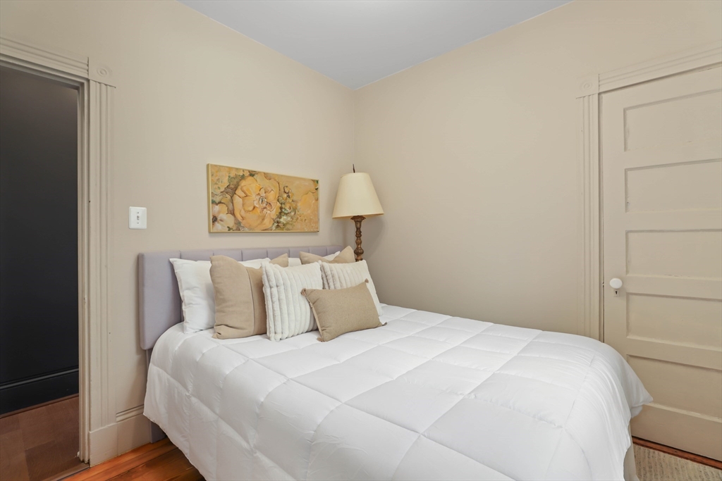 8 Spring Garden Street, Unit 3 Boston, MA 02125 - Photo 25 of 37 a bedroom with a bed and a painting on the wall