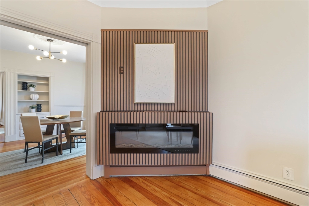 8 Spring Garden Street, Unit 3 Boston, MA 02125 - Photo 4 of 37 an empty room with wooden floor and a window