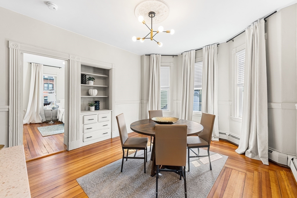 8 Spring Garden Street, Unit 3 Boston, MA 02125 - Photo 8 of 37 a view of a dining room with furniture and wooden floor