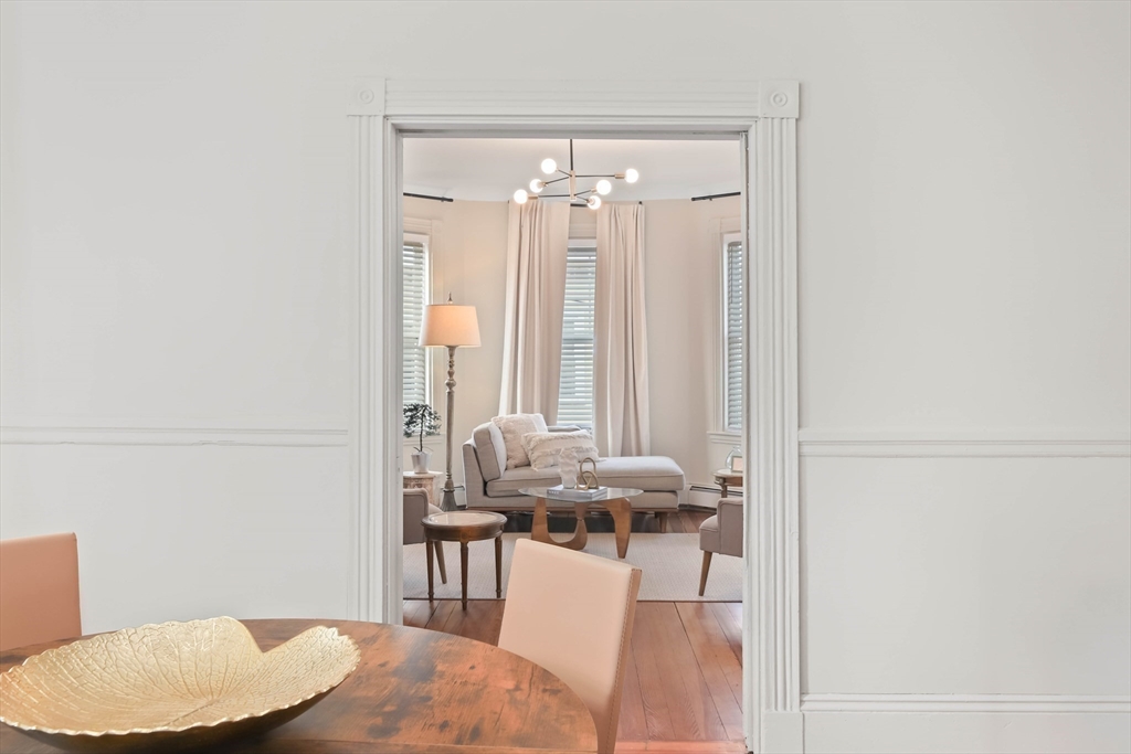 8 Spring Garden Street, Unit 3 Boston, MA 02125 - Photo 10 of 37 a dining room with furniture and a chandelier