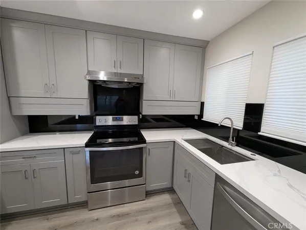 a kitchen with a stove and white cabinets