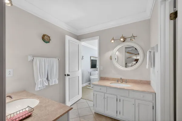 a en suite bathroom with a granite countertop double vanity sink and a mirror