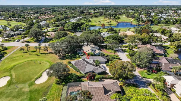 an aerial view of residential houses with outdoor space and trees
