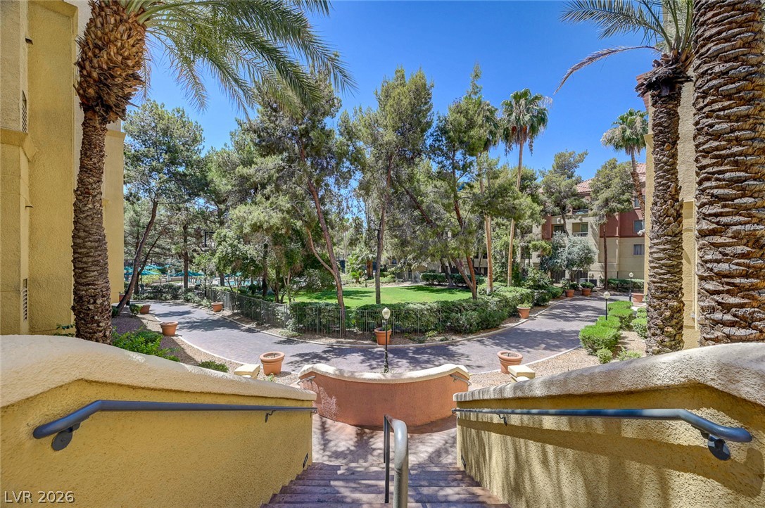 230 East Flamingo Road, Unit 106 Las Vegas, NV 89169 - Photo 32 of 66 Meandering pathways and verdant lawns define this charming residential complex with mature landscaping.