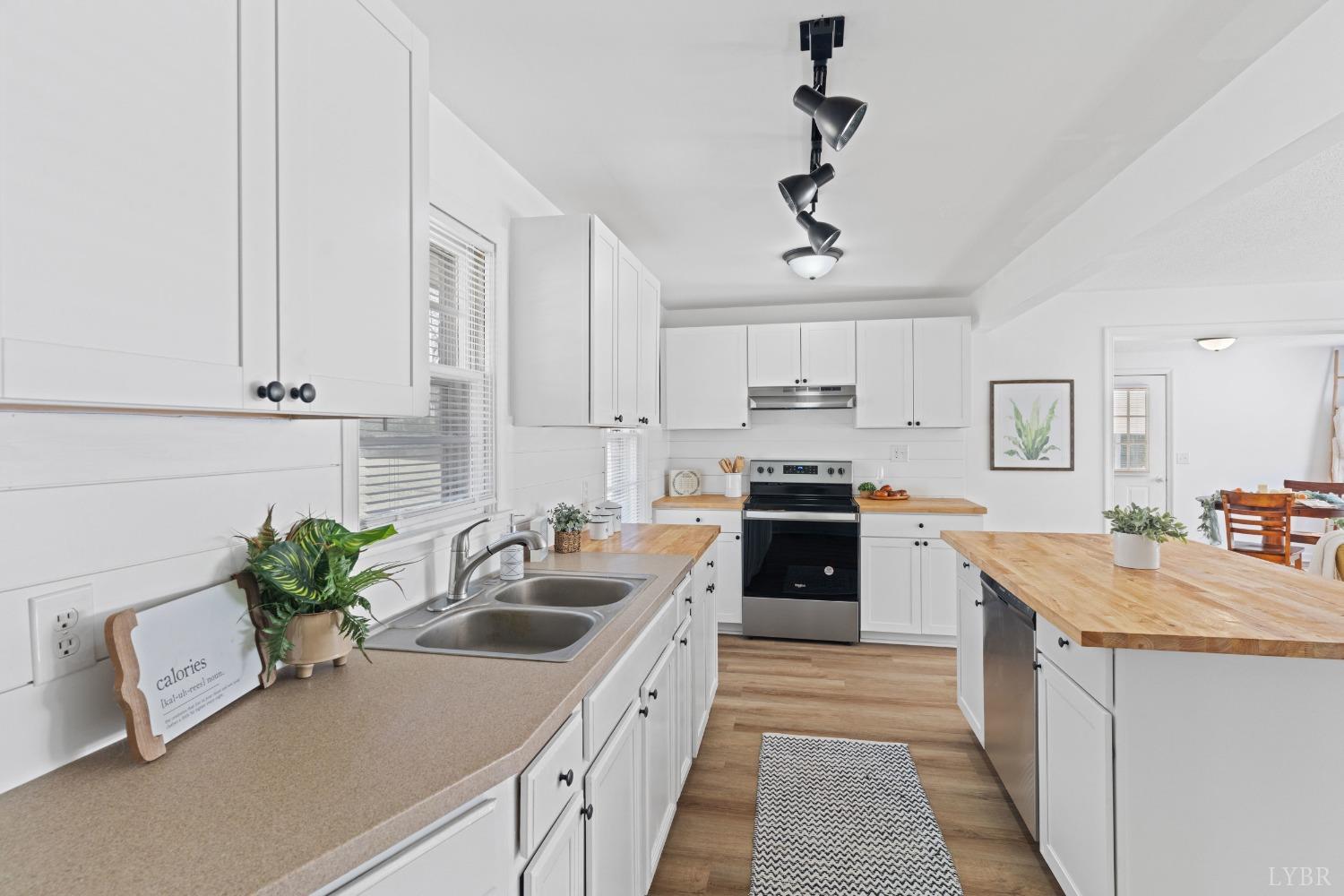 2529 Zion Road Gretna, VA 24557 - Photo 12 of 47 a kitchen with stainless steel appliances granite countertop a sink a stove and a refrigerator