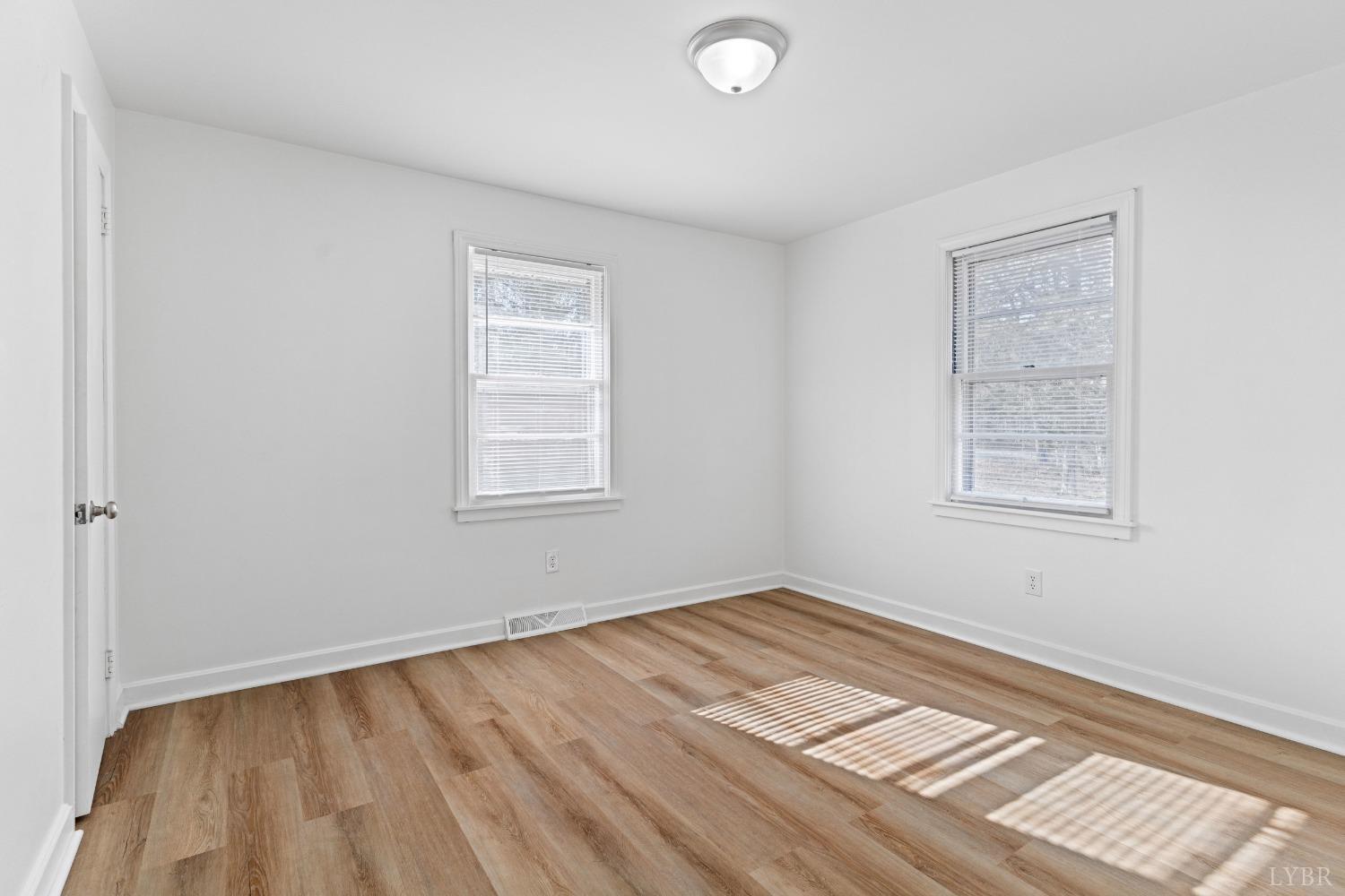 2529 Zion Road Gretna, VA 24557 - Photo 22 of 47 a view of an empty room with wooden floor and a window