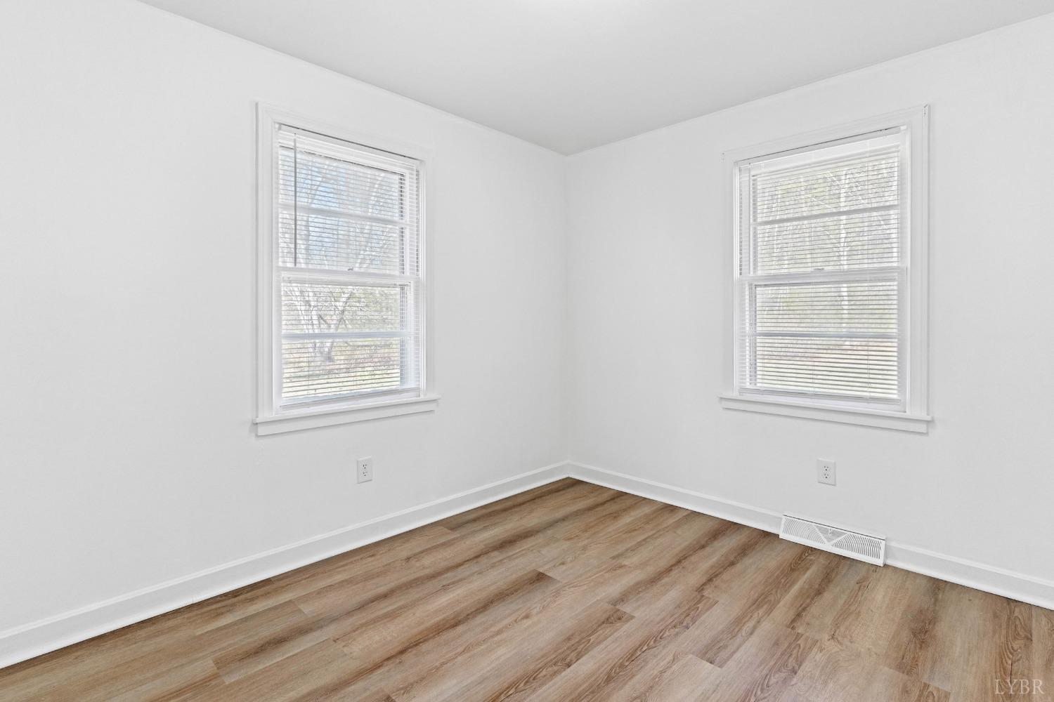 2529 Zion Road Gretna, VA 24557 - Photo 24 of 47 an empty room with wooden floor and windows