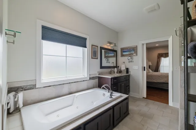 a en suite bathroom with a tub and a sink