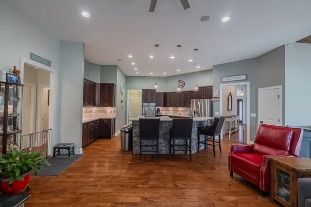 a living room with furniture and a dining table with kitchen view